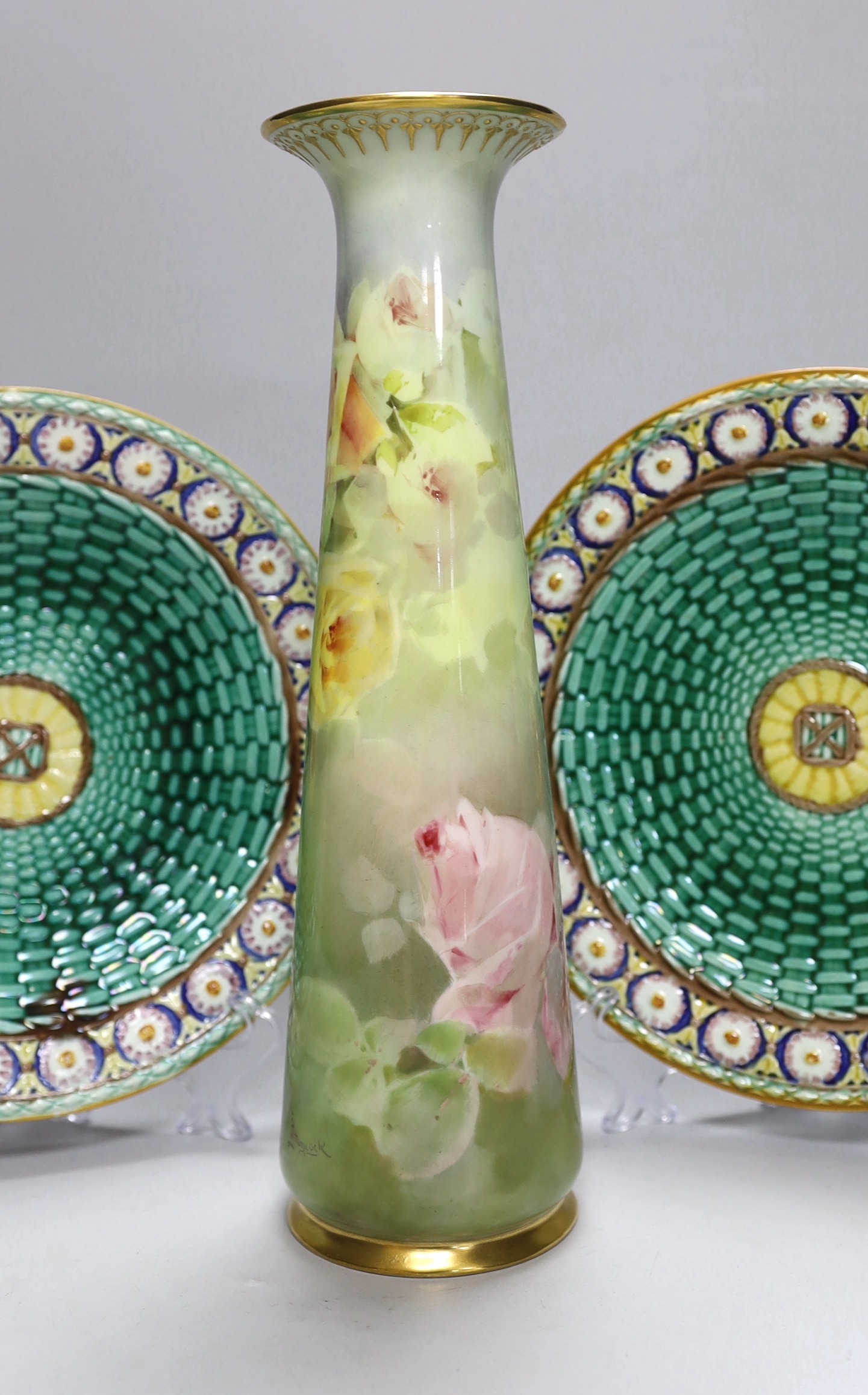 A pair of Wedgwood Majolica plates and a Royal Doulton floral vase painted by Joseph Hancock, 30cm high